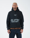 Black BJJ pullover hoodie front view on adult male model showing Jiu Jitsu Squad chest print and pocket [color:Black]