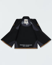 Kingz Legends Never Die Respect Youth Gi in Black – flat lay open jacket view: inner collar label Respect Is Earned Not Given text yellow trim crown