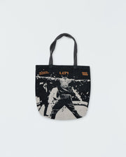 Kingz Legends Never Die Respect Youth Gi in Black – flat lay: collector's tapestry tote bag with Leandro Lo competition artwork