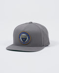 Kingz Jiu Jitsu Club Snapback Grey - Angled Front View Embroidered Round Patch Center Blue Gold Design Flat Brim Structured Fit Adjustable Snapback Cap BJJ Training Apparel [color:Grey]