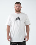 Kingz Less Talk Tee Black - Full Body Front View Male Athlete Black T-Shirt White Graphic Text "Less talk, more Action" Center Chest Comfortable Fit BJJ Training Apparel [color:Black]