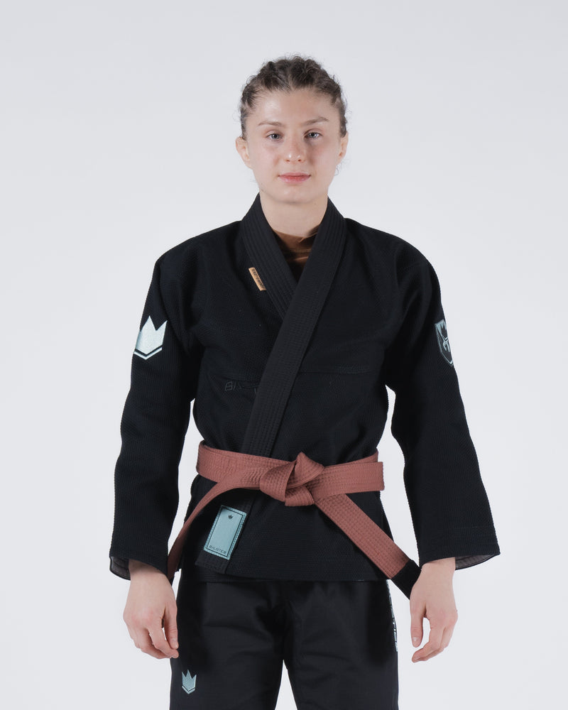 Kingz Balistico 4.0 Women's Jiu Jitsu Gi - Black - Front View Female Athlete Black Gi White Crown Badge Left Sleeve Embroidered Patches Brown Belt Contrast Modern Fit BJJ Gi Training [color:Black]