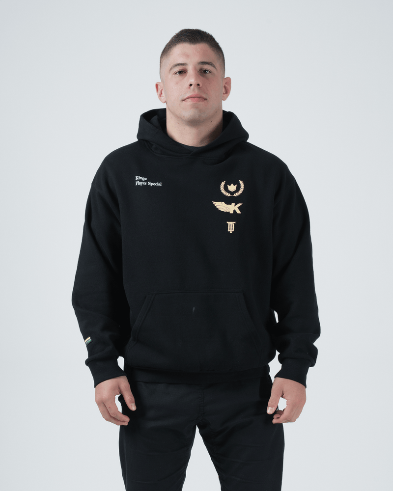 Kingz Player Special Hoodie Black - Front View Male Athlete Gold Chest Logos Kingz Text Left Chest Kangaroo Pocket Ribbed Cuffs Black Streetwear [color:Black]