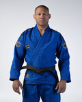 Kingz Comp 450 V6 Gi Blue - Front View Male Athlete Blue Gi Black Belt Crown Patches Shoulders Gold Text Chest Durable Weave Jiu Jitsu Gear Training Gi [color:Blue]