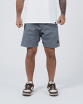 Kingz Casual Gi Shorts Grey Steel Blue-Grey - Full Body Front View Male Athlete Grey Ripstop Casual Shorts Above-Knee Cut Drawstring Waistband Black Woven Kingz Label Right Thigh White T-Shirt Brown Nike Dunk Sneakers Men's BJJ Lifestyle [color:Grey]