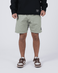 Kingz Casual Gi Shorts Sage Stone Green - Full Body Front View Male Athlete Sage Stone Green Ripstop Casual Shorts Above-Knee Cut Elastic Leg Hem Drawstring Waistband Black Woven Kingz Label Right Thigh Black Hoodie Brown Nike Dunk Sneakers Men's BJJ Lifestyle [color:Stone Green]