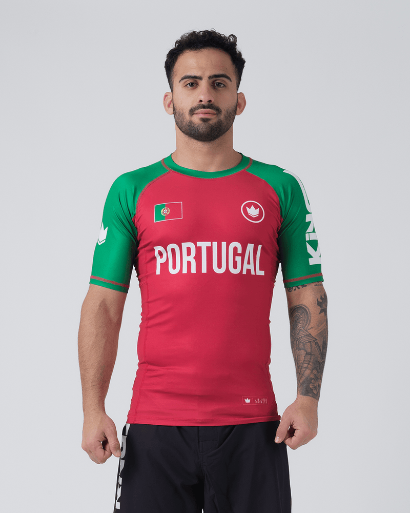 Kingz Jersey Rashguard - Portugal Red Green - Full Body Front View Male Athlete Red Body Green Sleeves Portugal Text Flag Crown Logo Chest KINGZ Sleeve Text BJJ No-Gi Rash Guard