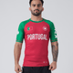 Kingz Jersey Rashguard - Portugal Red Green - Full Body Front View Male Athlete Red Body Green Sleeves Portugal Text Flag Crown Logo Chest KINGZ Sleeve Text BJJ No-Gi Rash Guard
