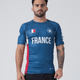 Kingz Jersey Rashguard - France Blue - Full Body Front View Male Athlete Blue Rashguard French Flag Chest Crown Badge Logo White "FRANCE" Text Red Side Panels BJJ Training Rash Guard