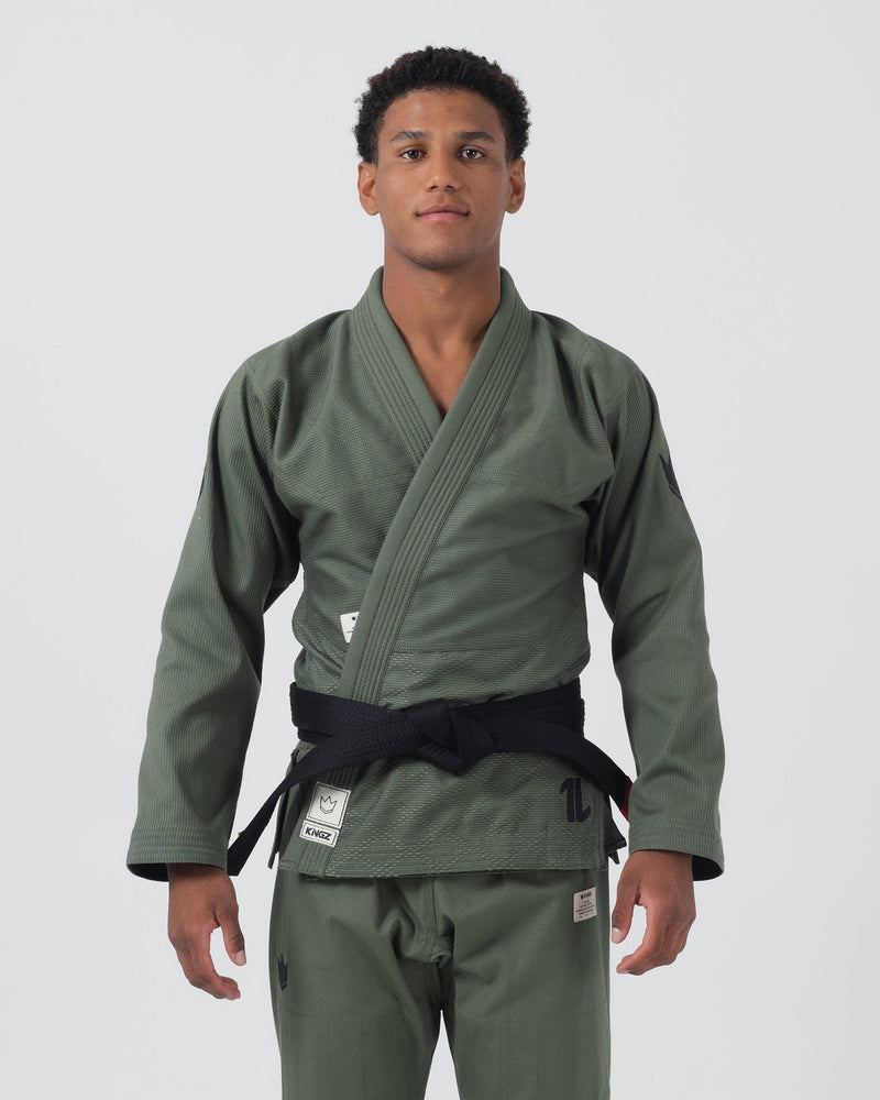 Kingz The ONE Jiu Jitsu Gi Military Green - Full Body Front View Male Athlete Military Green Kimono Black Belt Kingz Logo Patches Durable Weave Limited Edition BJJ Training Gi