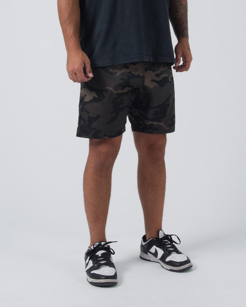 Kingz Casual Gi Shorts Camo Dark Military - Full Body Front View Male Athlete Dark Green Black Brown Military Camouflage Ripstop Shorts Above-Knee Drawstring Waistband Black Woven Kingz Label Right Thigh Dark Navy T-Shirt Black White Dunk Sneakers Men's BJJ Lifestyle [color:Dark/Camo]