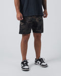 Kingz Casual Gi Shorts Camo Dark Military - Full Body Front View Male Athlete Dark Green Black Brown Military Camouflage Ripstop Shorts Above-Knee Drawstring Waistband Black Woven Kingz Label Right Thigh Dark Navy T-Shirt Black White Dunk Sneakers Men's BJJ Lifestyle [color:Dark/Camo]
