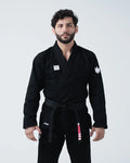 Kingz Kore V2 Jiu Jitsu Gi - Black - Front View Male Athlete Black Gi White Crown Shoulder Patch Kingz Logo Waist Black Belt BJJ Training Gi [color:Black]