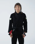 Kingz The ONE V2 Women's Jiu Jitsu Gi - Black - Full Body Front View Female Athlete Black Gi Crown Logo Sleeves Red and Black Belt Patch Modern Fit Durable Fabric BJJ Gi Training [color:Black]