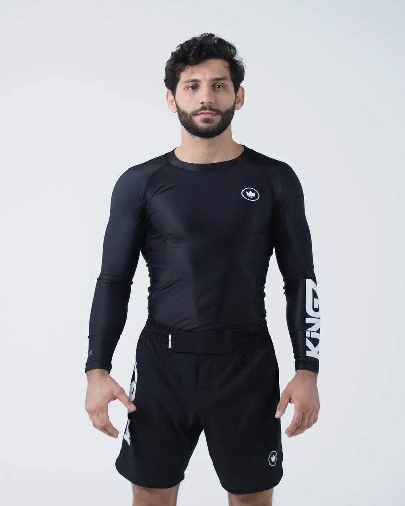 Kingz Kore V2 Long Sleeve Rashguard Black - Full Body Front View Male Athlete Black Rashguard White KINGZ Sleeve Text Crown Logo Chest Snug Fit BJJ No-Gi Grappling Rash Guard [color:Black]