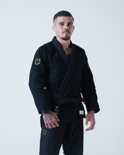 Kingz Legends Never Die Respect Gi in Black – full body front view on male model: black gi gold crown shoulder patch Kingz logo patch waist durable