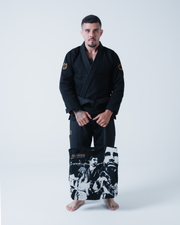 Kingz Legends Never Die Respect Gi in Black – full body front view on male model: black gi crown badge shoulders tote bag graphic design