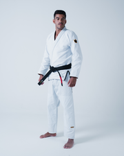 Kingz Legends Never Die Respect Gi in White – full body front view on male model: white gi black belt crown badge sleeve KINGZ logo pant leg