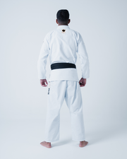 Kingz Legends Never Die Respect Gi in White – back view on male model: white gi black belt crown logo upper back black text right leg