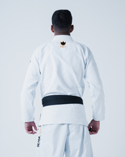 Kingz Legends Never Die Respect Gi in White – back view on male model: black belt crown badge collar ultra light text side panel