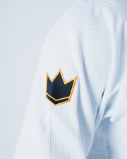 Kingz Legends Never Die Respect Gi in White – close-up detail view: embroidered black gold crown badge textured fabric