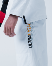 Kingz Legends Never Die Respect Gi in White – close-up side view on male model: black red sleeve detail ULTRA LIGHT vertical text white fabric