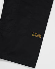 Kingz Legends Never Die Respect Women's Gi in Black – close-up detail view: black fabric gold KINGZ text embroidery ripstop weave durable construction