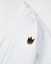 Kingz Legends Never Die Respect Women's Gi in White – close-up detail view: black crown badge yellow outline textured fabric