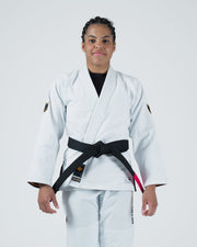 Kingz Legends Never Die Respect Women's Gi in White – front view on female model: black belt crown badge sleeves black inner collar KINGZ patch front