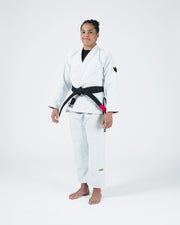 Kingz Legends Never Die Respect Women's Gi in White – full body front view on female model: black belt crown badge sleeve KINGZ text pant leg