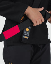 Kingz Legends Never Die Respect Women's Gi in Black – close-up detail view: black gi red patch Kingz logo yellow crown badge LL77 text durable fabric