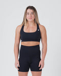 Kingz Kore Womens Sports Bra - Black - Full Body Front View Female Athlete Black Sports Bra White Crown Logo Left Chest Sleek Design Comfortable Fit BJJ Training MMA
