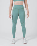 Kingz Kore Women's Grappling Spats Green - Full Body Front View Female Athlete Sage Teal Green V-Seam Front Detail Side Pocket Right Thigh High-Waist Matching Sports Bra Full-Length Compression Fit Women's No-Gi BJJ Spats Kore Collection [color:Sage Green]