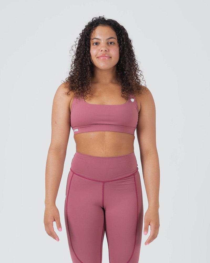 Kingz Kore Women's Sports Bra Dusty Rose - Full Body Front View Female Athlete Square Neckline White Crown Logo Left Strap KINGZ Text Band Seamless Fit Women's Training Sports Bra [color:Dusty Rose]