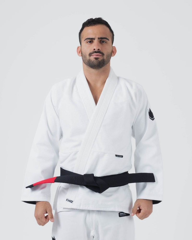 Kingz Kore V2 Jiu Jitsu Gi White - Front View Male Athlete White Gi Black Belt Kingz Logo Left Sleeve Crown Badge Durable Fabric 2023 Edition BJJ Kimono Training [color:White]