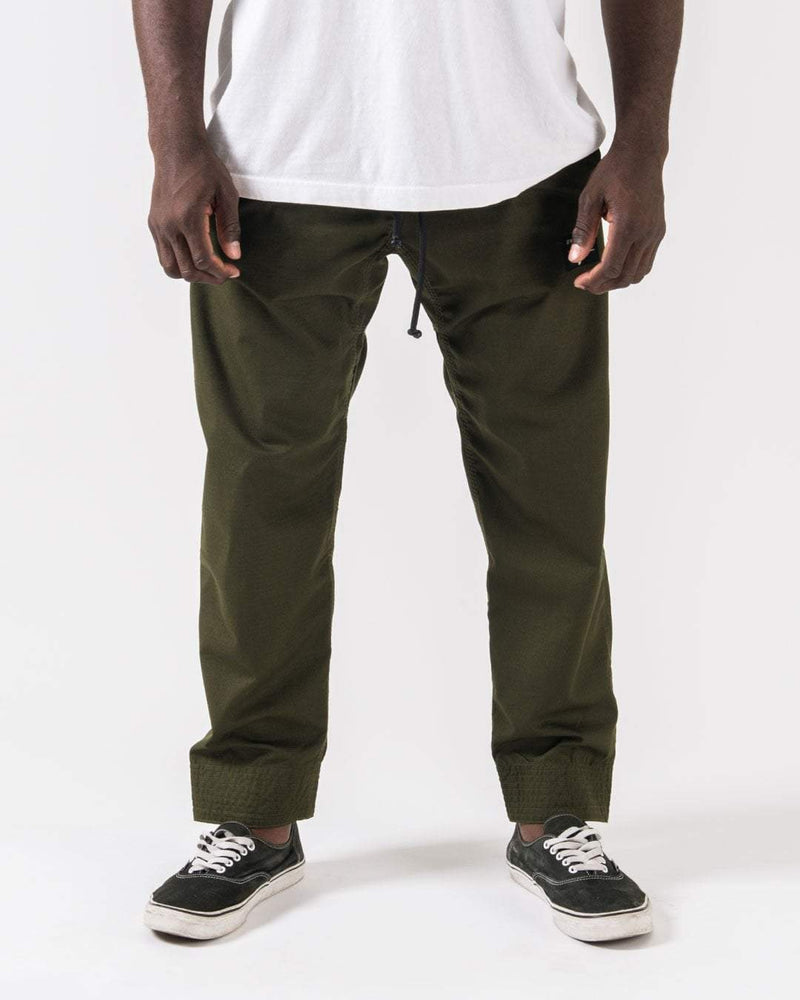 Kingz Casual Rip Stop Gi Pants Military Green - Front View Male Athlete Military Green Drawstring Waist Elastic Cuffs Relaxed Fit Durable Fabric BJJ Gi Training [color:Military Green]